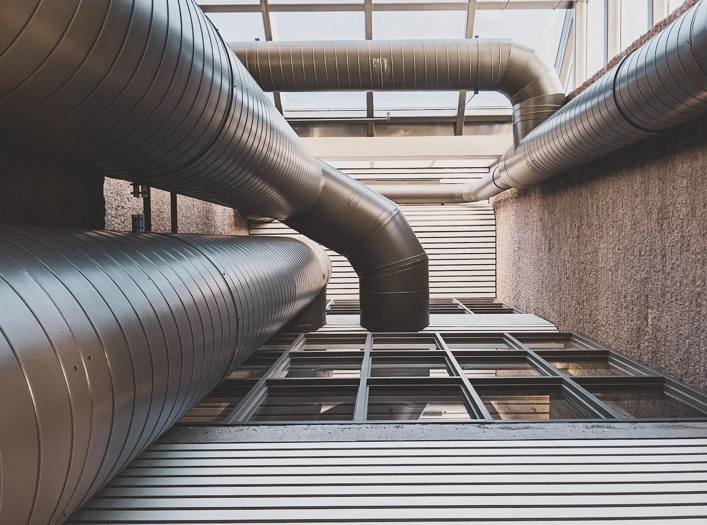 Clean industrial ductwork running across a ceiling